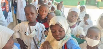 children in the school yard posing for the camera