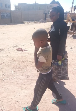 a lady in black accompanying a child she rendered help to