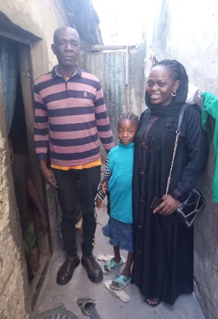 two adults caring for a child-girl