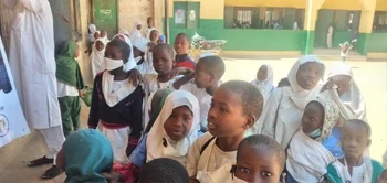 children in the school yard waiting for AprilMission Group