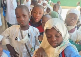 children in the school yard posing for the camera