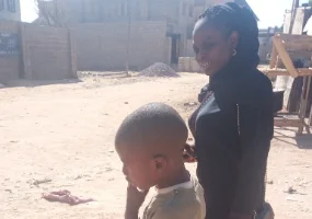 a lady in black accompanying a child she rendered help to