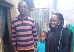 two adults caring for a child-girl